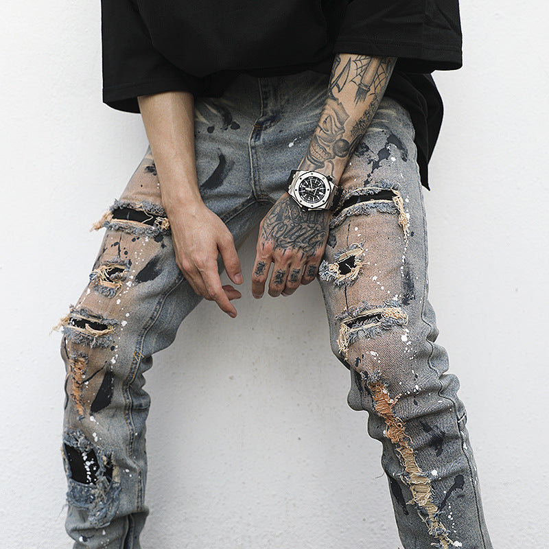 Distressed And Ink-sprayed Small-footed Jeans With Ripped Patches