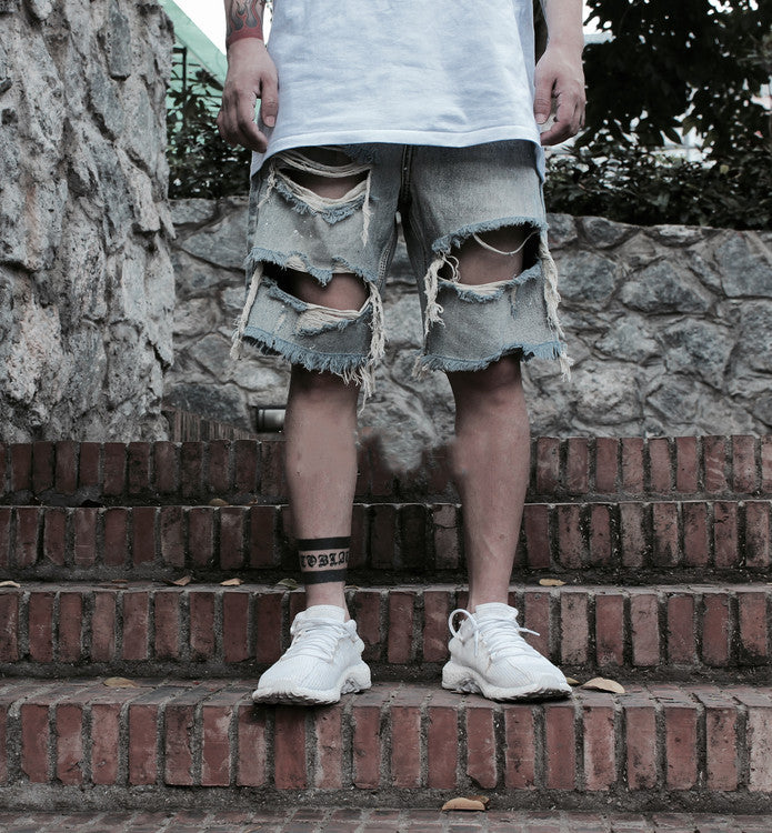 Old denim shorts with ripped paint