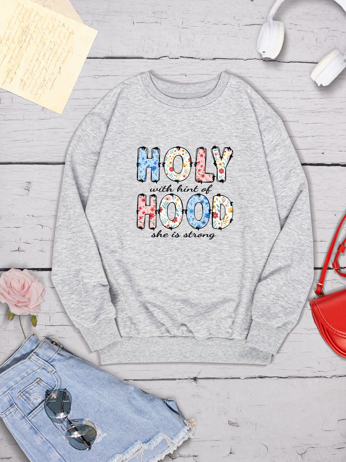 HOLY WITH HINT OF HOOD SHE IS STRONG Round Neck Sweatshirt 